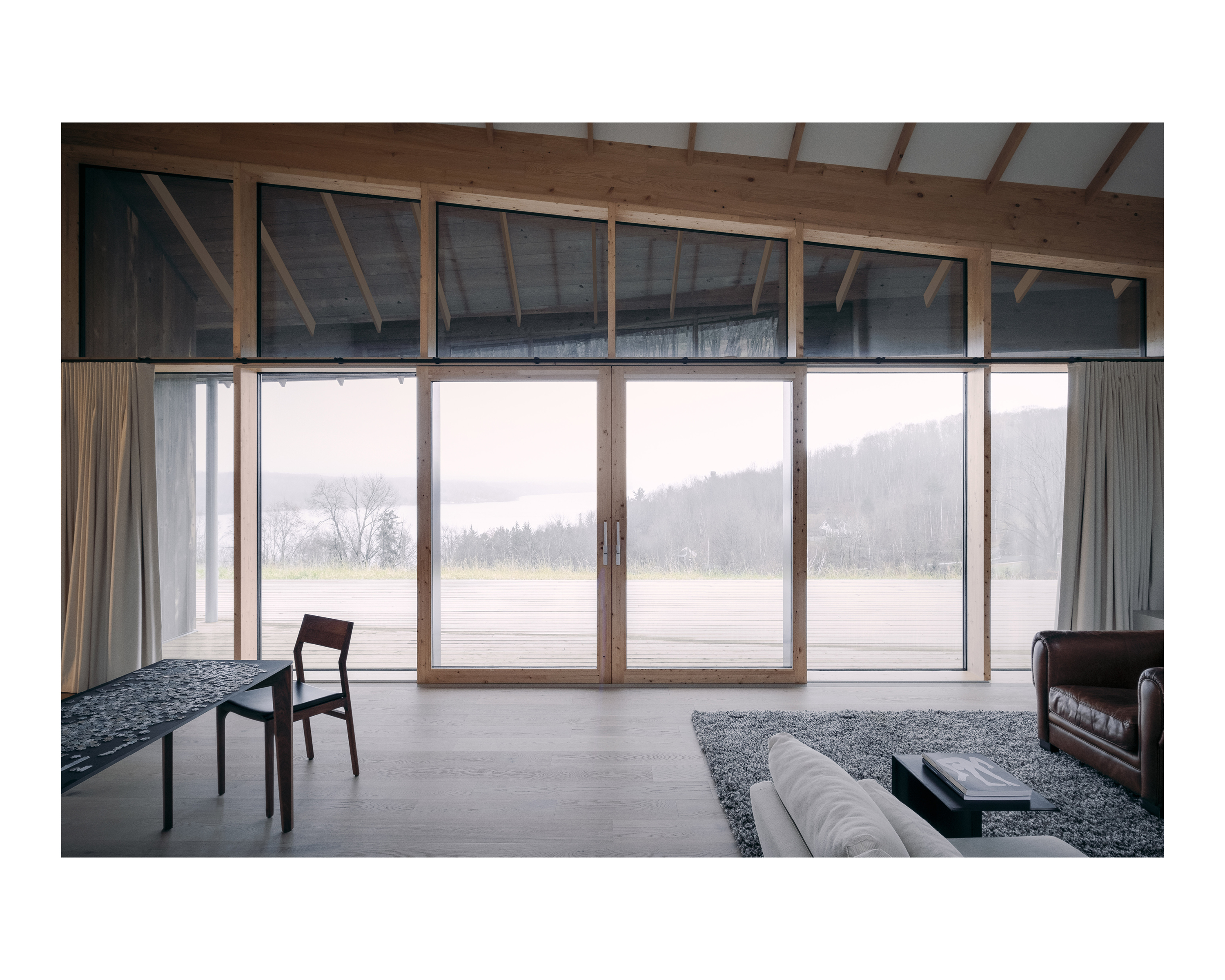 Interior view of house showing large windows and wood joints